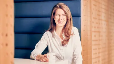 Portrait of Johanna Michelfelder sitting at a table with a coffee cup.
