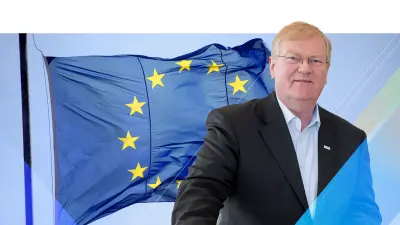 Stefan Hartung stands in front of the European flag in the background.