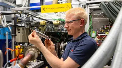 Associate works at a Bosch hydrogen engine.