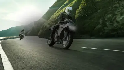 Two motorcycles on a coastal road in the sunshine equiped with Bosch technology
