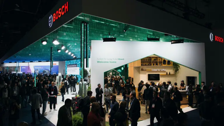 A vibrant, wide shot of the Bosch booth at a technology expo.