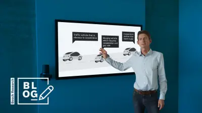 Bosch Research Expert explaining the concept of cooperative driving in a conference room at the Bosch Research Campus in Renningen, Germany