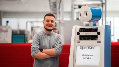 Bosch Research expert Timm Linder with a humanoid robot.