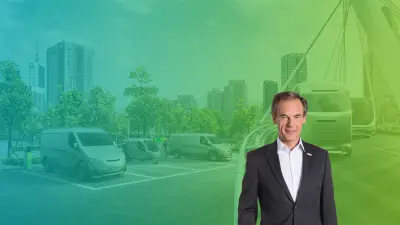 Bosch CEO Volkmar Denner stands in front of a green background that shows a busy road.