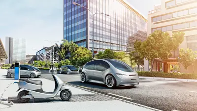 An electric car and an E-Scooter on a street