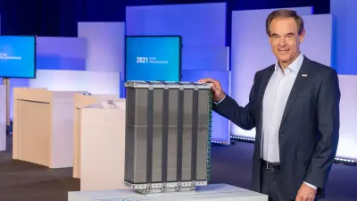 Dr. Volkmar Denner stands next to a fuel cell.