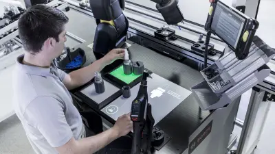 A man working with an industrial robot.