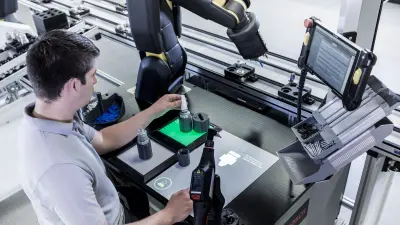 A man and a robot work together.
