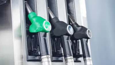 Three nozzle valves at a gas station. On one is the inscription “efuel”. 