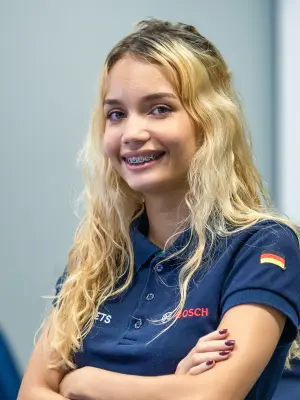 Nicolly Cristina Cruz Storoni with a dark blue shirt and long blond hair