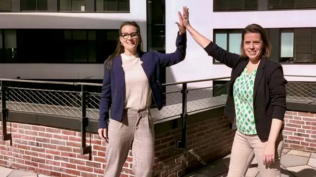 Kira-Alena and Franziska from Germany high-five each other and smile at the camera.