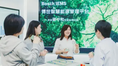 Lei from China chats with her team and smiles.