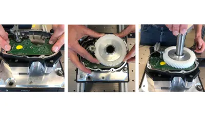 Manual e-bike assembly process: manual PCB placement, manual gear placement, manual peg insertion.