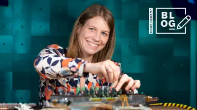 Dr. Marina Keller, research engineer for electrical drives and electrical machines at Bosch Research in front of a power electronics device in the lab