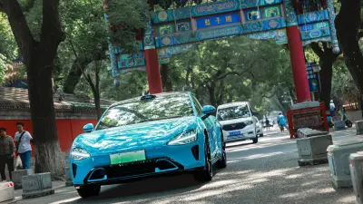 The electric vehicle SU7 from Xiaomi in front of a Chinese gate near the Beijing Temple of Confucius.