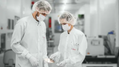 Mirjam Henn with her team colleague at the cleanroom at the Bosch Research campus in Renningen, Germany. Researching wide bandgap power transistors to enhance the efficiency of electromobility.