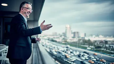 Bosch employee Murat Ozcihan stands on a balcony and looks down onto the city traffic of Istanbul.