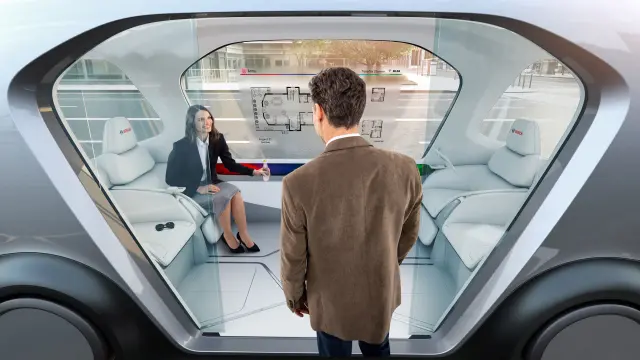 Two people use a Bosch IoT shuttle.