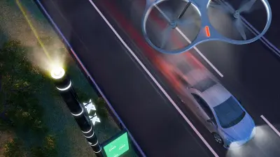 Eine Smart Road von oben, ein intelligenter Mast, eine Drohne und ein fahrendes Auto.