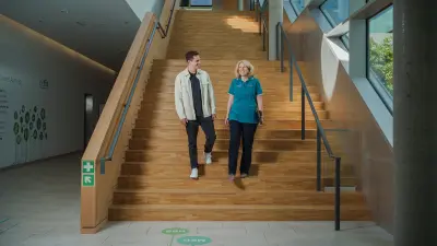Antje and Max are running down a wooden staircase