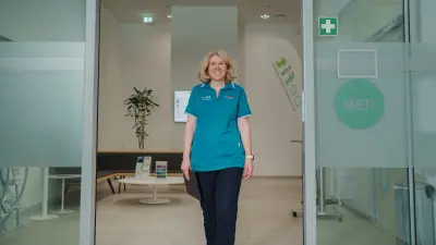 Antje walks through the door of the medical area, smiling