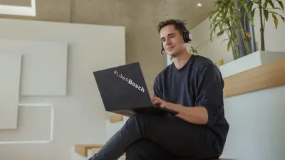 Max is sitting at his laptop, working