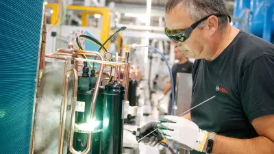 A Bosch associate works on heat pump at the Bosch site in Aveiro, Portugal.