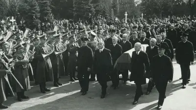Coffin with pallbearer and band