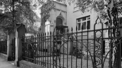 View of a villa through the garden gate
