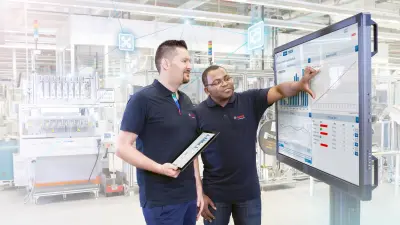 A man is showing another man something on a screen.