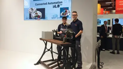 A young man and a young woman stand in workwear of Bosch behind the antiq