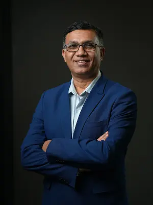 Guruprasad Mudlapur, President of Bosch India. A man with short dark hair and black-rimmed glasses.