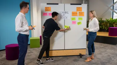 Hamza, Antonio and Karolina work with sticky notes on a workshop wall.