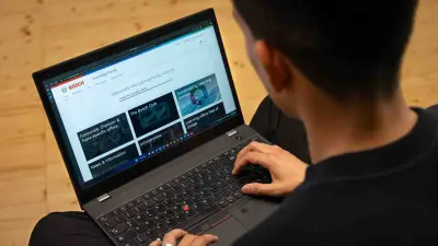 A laptop screen shows the Bosch Learning Portal.