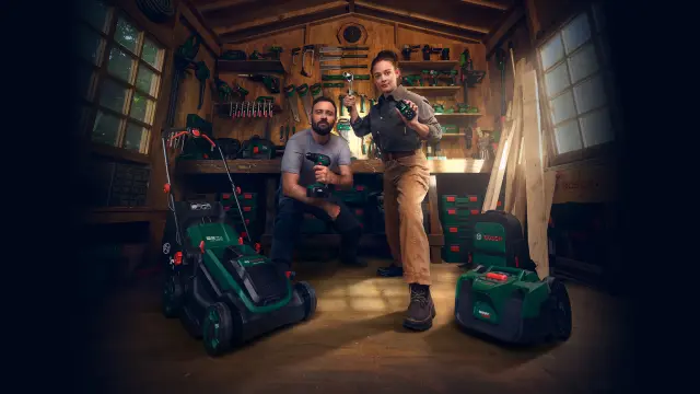 A man and a woman are standing in a workshop that is fully equipped with tools and devices from Bosch Power Tools.