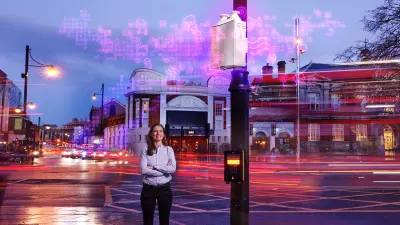 Bosch employee Dr. Maria Martínez Prada stands next to an air quality monitoring box on Brixton Road in south London.