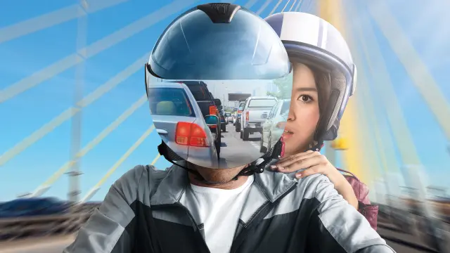 Close-up man and woman on a motorcycle.