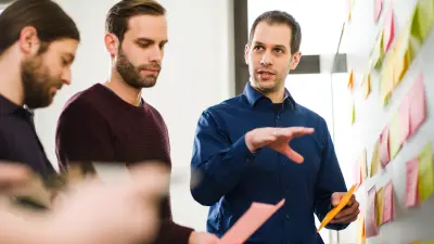 Tobias Richter and two colleagues inside the manufacturing plant.