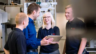 Tobias Richter with his colleagues inside the manufacturing plant.