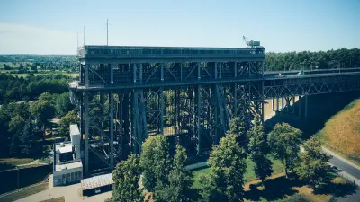 Large steel ship lift structure surrounded by trees and access roads.