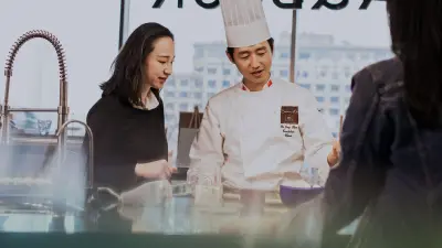 A customer and a cook in the show kitchen in the flagship store of Tmall