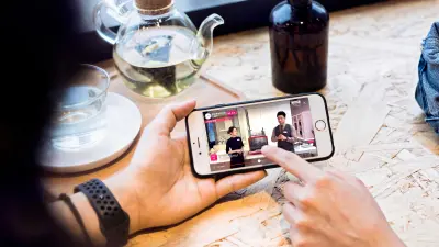Someone is watching a video of a cooking show on their smartphone.