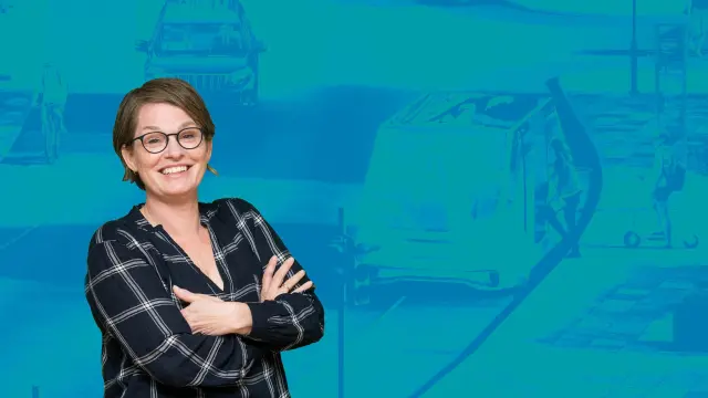 Malene Freudendal-Pedersen in front of a blue wallpaper.