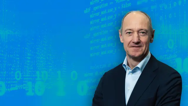 Roland Bush against a blue background.