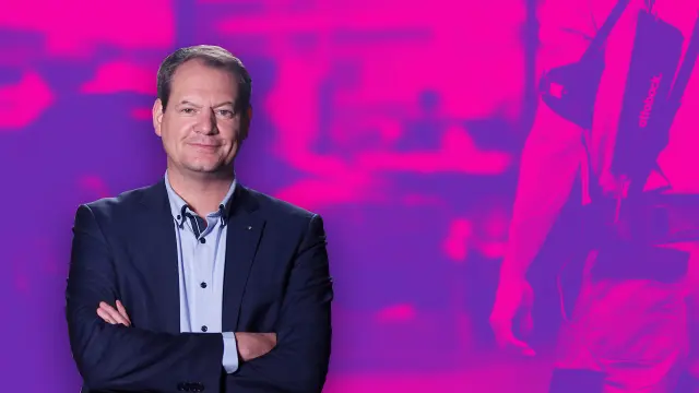 Sarik Weber in front of a fuchsia wallpaper.