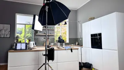 We see the kitchen, which is illuminated with spotlights.