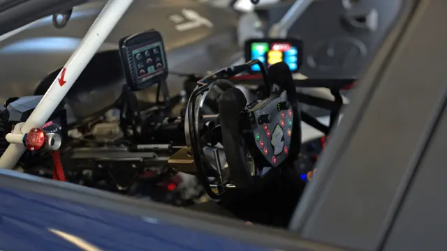 View through the side window of the racing car into the cockpit with the hand-controlled braking system.