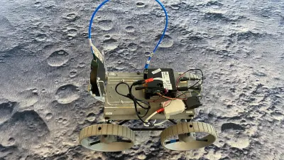 A small CubeRover™ being tested on a realistic lunar surface carpet.