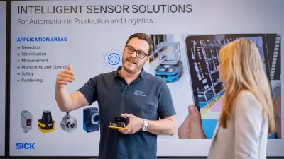 Person explaining sensor equipment in front of a technical presentation.