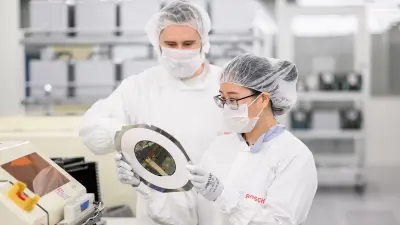Two associates during work with a wafer.